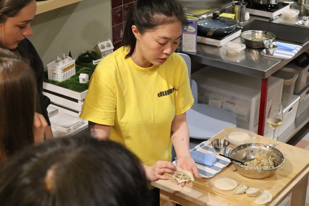 Dee teaching dumpling folding multiple shapes at dumps world experience